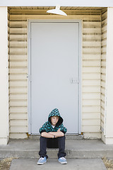 Image showing Boy Sitting on a Curb