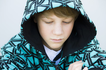 Image showing Boy in Sweatshirt Looking Down