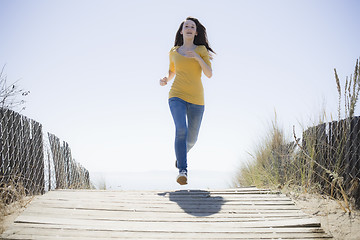 Image showing Girl Running On Beach Walkway