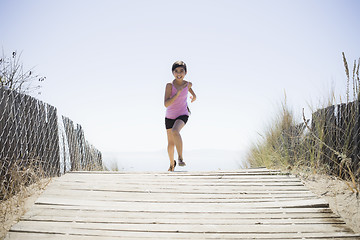 Image showing Girl Running On Beach Walkway