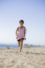 Image showing Smiling Girl Running on beach