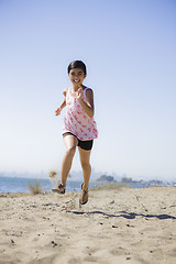 Image showing Smiling Girl Running on Beach