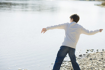 Image showing Boy Throwing Stones