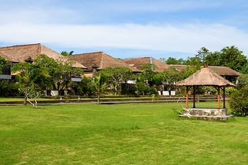 Image showing Hut and villa over field