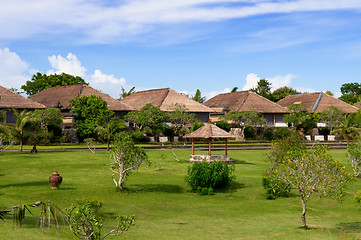 Image showing Hut and villa over field