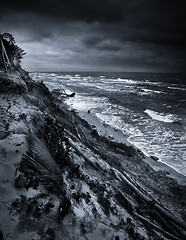 Image showing Baltic coast with eroded beach and landslide after storm dramatic sky b/w