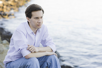 Image showing Teenage Boy Sitting on Rocks