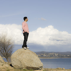 Image showing Man Standing on Rock Looking into Distance 