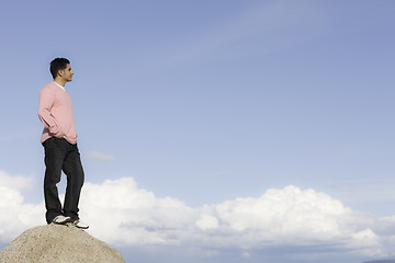 Image showing Man Standing on Rock Looking into Distance