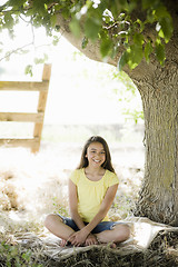 Image showing Young Girl Sitting Under Tree