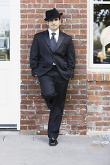 Image showing Man in Suit and Tie Leaning against Wall