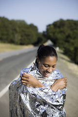 Image showing Smiling Woman in Space Blanket 
