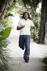 Image showing Teenage Boy Running on Sidewalk