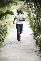 Image showing Teenage Boy Running on Sidewalk