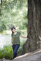 Image showing Young Woman Standing by Tree