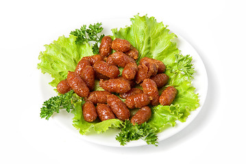 Image showing grilled sausages on green lettuce