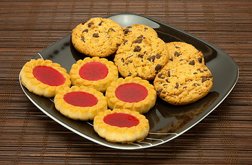 Image showing plate of cookies on dark brown background