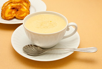 Image showing Closeup of coffee with milk in white cup and a palmier pastry