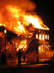 Image showing Firefighter fighting burning house.