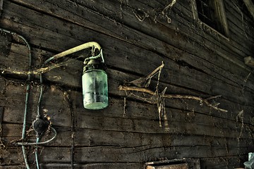 Image showing Old lamp in rural barn