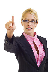 Image showing a young beautiful businesswoman making an imaginary choice, focus on finger