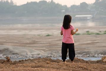 Image showing Laotian girl watching Mekong river