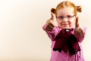 Image showing Portrait of cute elegant redhead girl showing thumbs up