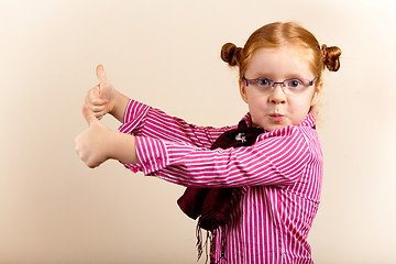 Image showing Portrait of cute elegant redhead girl showing thumbs up