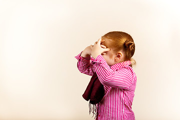 Image showing Portrait of cute elegant redhead girl face covered with crossed hands