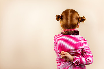 Image showing Portrait of cute elegant redhead girl from back with crossed fingers