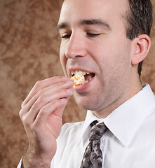 Image showing Business Man Eating Orange