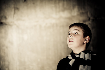 Image showing Young boy looking up with hope in his eyes copy space high contrast flattened colours