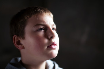 Image showing Young boy looking up with hope in his eyes shallow DOF