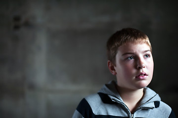 Image showing Young boy looking up with hope in his eyes