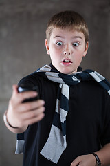 Image showing scarry teenaiger looking at his mobile phone - you've got the message!