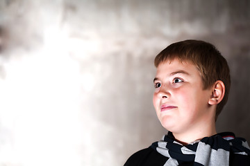 Image showing Young boy looking up with hope in his eyes copy space Strong main light