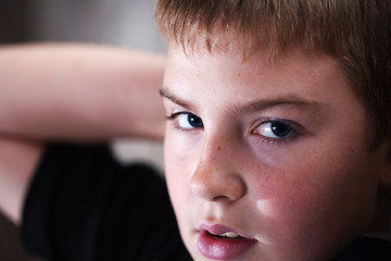 Image showing Young boy looking up with hope in his eyes
