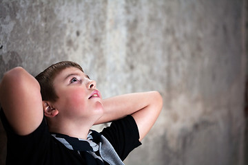 Image showing Young boy looking up with hope in his eyes