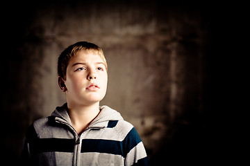 Image showing Young boy looking up with hope in his eyes High contrast