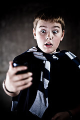 Image showing scarry teenaiger looking at his mobile phone - you've got the message! High contrast