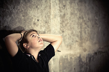 Image showing Young boy looking up with hope in his eyes high contrast 