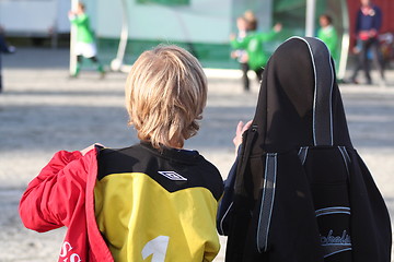 Image showing Boys watcing a football match