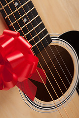 Image showing Guitar Strings with Red Ribbon