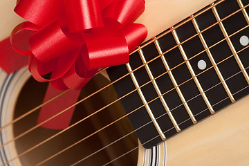 Image showing Guitar Strings with Red Ribbon