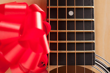 Image showing Guitar Strings with Red Ribbon