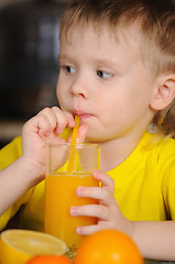 Image showing The child drinks juice