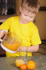 Image showing The child drinks juice