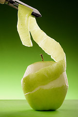 Image showing peeled green apple and peeler