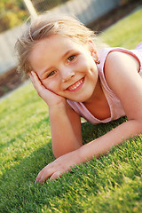 Image showing Happy girl relaxing on a grass