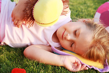 Image showing Happy girl relaxing on a grass